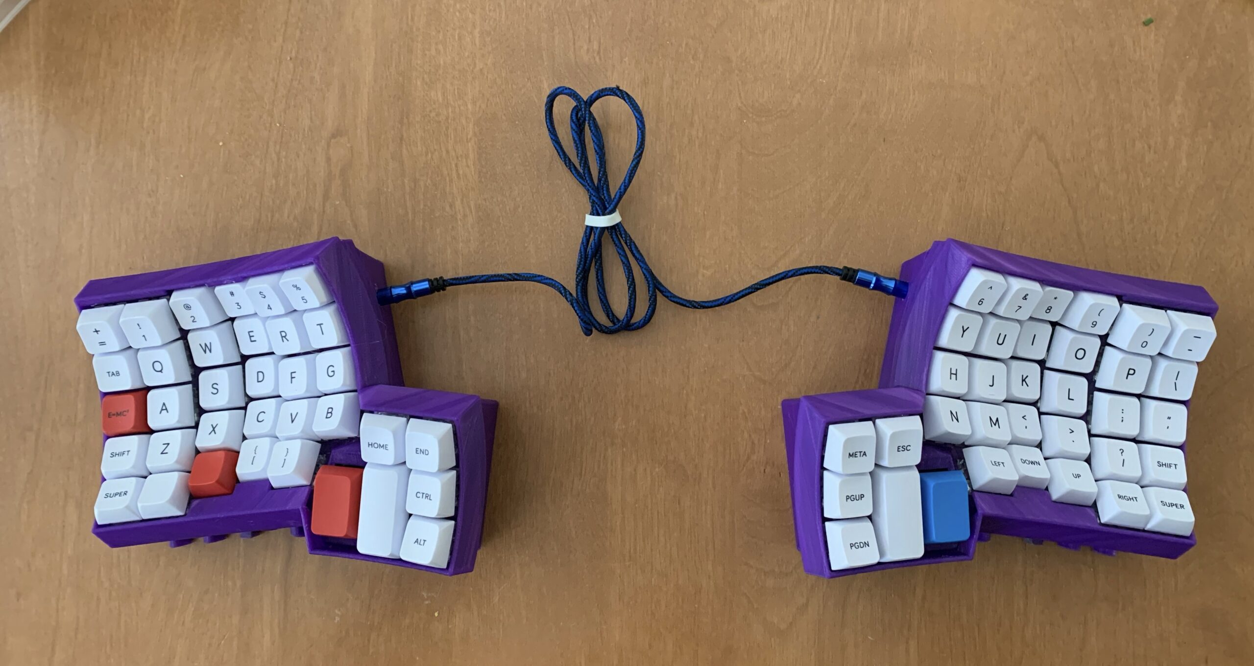 Dactyl Lightcycle keyboard with purple PLA house, white and blue MelGeek keys.